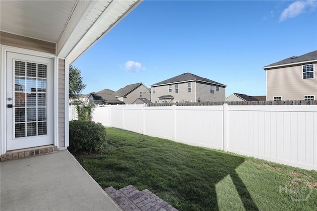 view of yard featuring a residential view and a patio area
