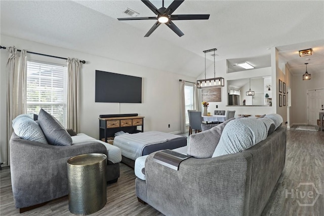 living room with wood finished floors, ceiling fan, vaulted ceiling, and baseboards