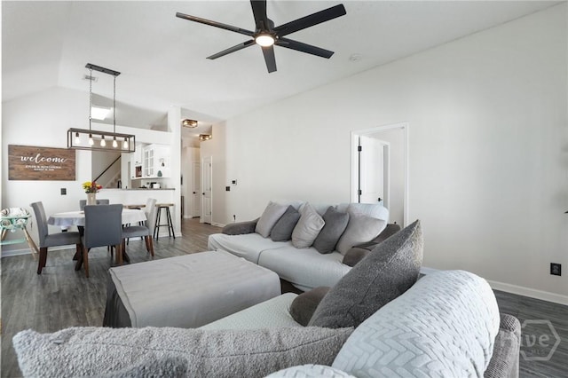 living area with lofted ceiling, baseboards, ceiling fan, and wood finished floors