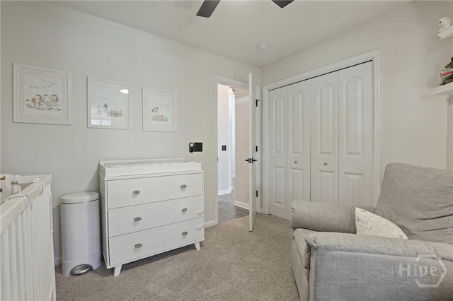 sitting room with light carpet, a ceiling fan, and baseboards