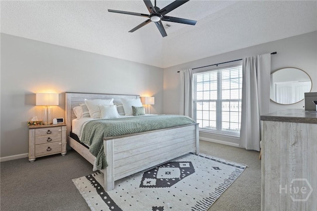 carpeted bedroom featuring baseboards, vaulted ceiling, a textured ceiling, and a ceiling fan