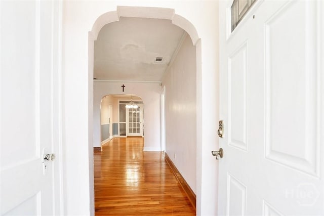 2120 E 39th St, Savannah, GA 31404 - hallway with arched walkways, light wood finished floors, and baseboards