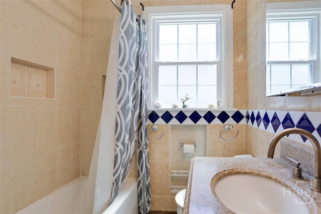 2120 E 39th St, Savannah, GA 31404 - full bath with toilet, plenty of natural light, shower / bath combo with shower curtain, vanity, and tile walls