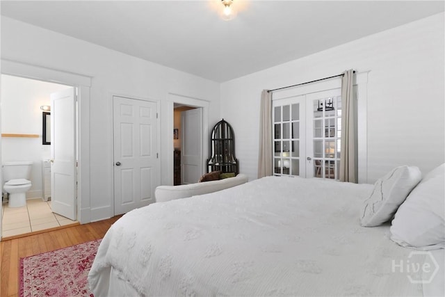 1216 E 31st St, Savannah, GA 31404 - bedroom featuring wood finished floors, ensuite bathroom, and french doors