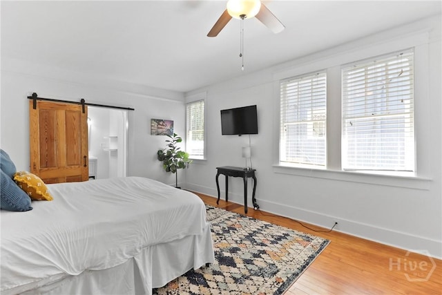 1216 E 31st St, Savannah, GA 31404 - bedroom with baseboards, a barn door, and wood finished floors