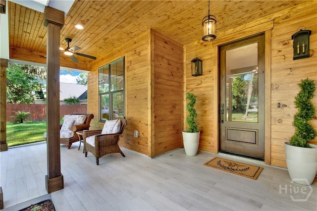property entrance featuring fence and a porch