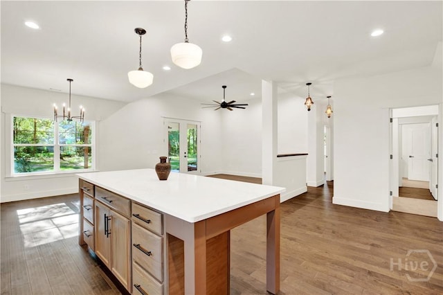 kitchen with recessed lighting, dark wood finished floors, baseboards, a center island, and light countertops