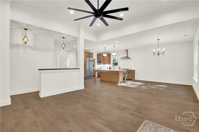 unfurnished living room featuring dark wood finished floors, crown molding, recessed lighting, baseboards, and a chandelier