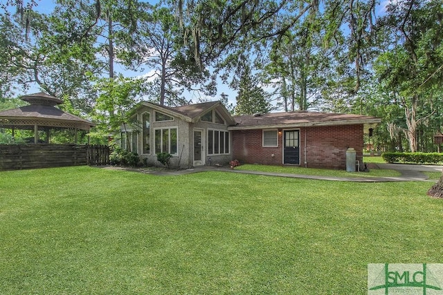 156 Lansing St, Brunswick, GA 31525 - rear view of house with a gazebo and a yard