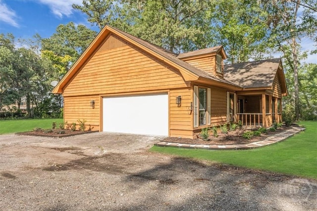 view of front of house with driveway, an attached garage, and a front yard