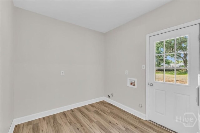 washroom with hookup for a washing machine, light wood-style flooring, baseboards, and gas dryer hookup
