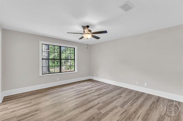 empty room featuring wood finished floors, ceiling fan, and baseboards