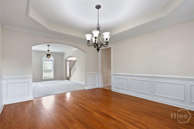 119 Sutton Ln, Pooler, GA 31322 - empty room featuring arched walkways, a chandelier, a raised ceiling, wood finished floors, and ornamental molding