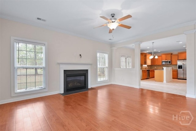 119 Sutton Ln, Pooler, GA 31322 - unfurnished living room with ornate columns, light wood-style floors, ceiling fan, a fireplace with flush hearth, and ornamental molding