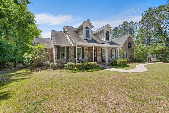 784 Ebenezer Rd, Rincon, GA 31326 - new england style home with covered porch, brick siding, and a front lawn