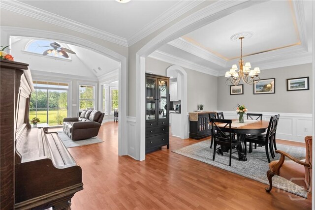 784 Ebenezer Rd, Rincon, GA 31326 - dining space featuring wood finished floors, a ceiling fan, ornamental molding, arched walkways, and a chandelier