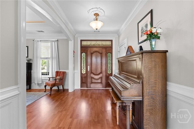 784 Ebenezer Rd, Rincon, GA 31326 - entryway with crown molding, wood finished floors, a wainscoted wall, and a decorative wall