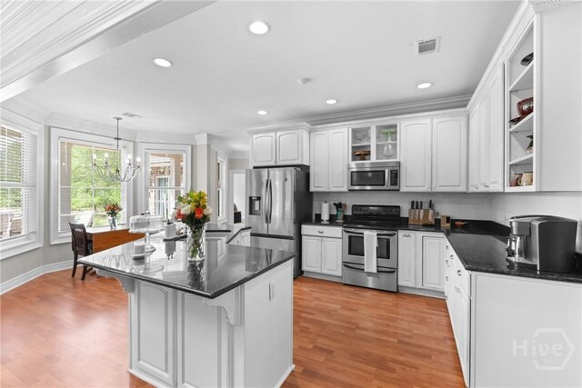 784 Ebenezer Rd, Rincon, GA 31326 - kitchen with appliances with stainless steel finishes, a chandelier, light wood finished floors, crown molding, and white cabinets