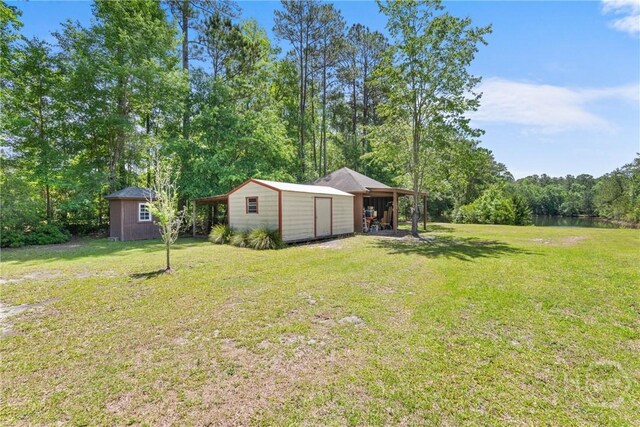 784 Ebenezer Rd, Rincon, GA 31326 - view of green lawn with a storage shed and an outbuilding