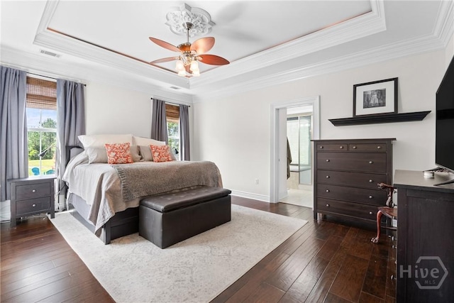 784 Ebenezer Rd, Rincon, GA 31326 - bedroom with a tray ceiling, multiple windows, dark wood finished floors, and crown molding