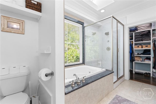 784 Ebenezer Rd, Rincon, GA 31326 - full bathroom featuring a shower stall, toilet, a skylight, a bath, and tile patterned floors