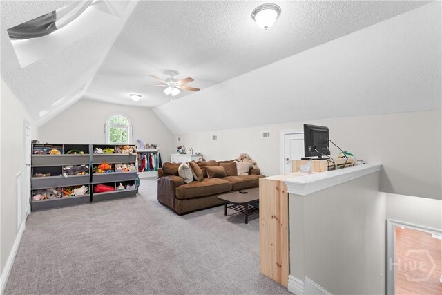 784 Ebenezer Rd, Rincon, GA 31326 - living area with vaulted ceiling, carpet floors, a textured ceiling, a ceiling fan, and baseboards