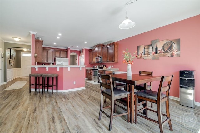 417 Keiffer Dr, Rincon, GA 31326 - dining room with arched walkways, light wood-style flooring, crown molding, baseboards, and recessed lighting