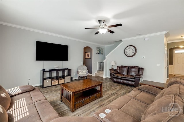 417 Keiffer Dr, Rincon, GA 31326 - living room featuring arched walkways, ornamental molding, a ceiling fan, baseboards, and stairs