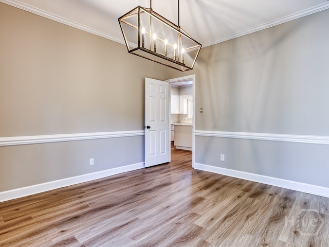 3 Riding Ln, Savannah, GA 31411 - unfurnished room featuring ornamental molding, a chandelier, wood finished floors, and baseboards
