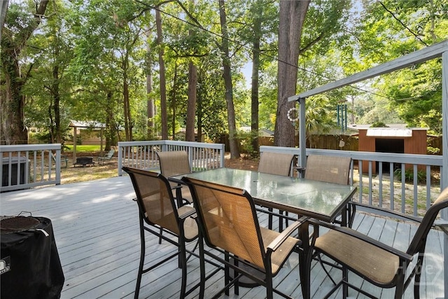 5633 Lafitte Dr, Savannah, GA 31406 - wooden deck with a fenced backyard, outdoor dining space, and an outdoor structure