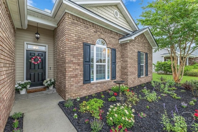 property entrance featuring brick siding