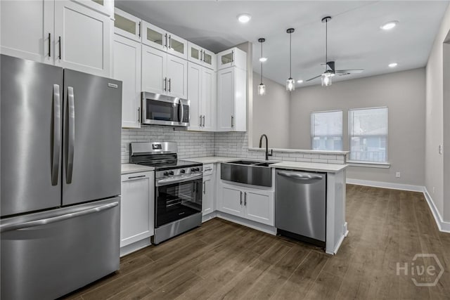 17 Nelson St, Savannah, GA 31415 - kitchen with appliances with stainless steel finishes, a sink, a ceiling fan, a peninsula, and light countertops