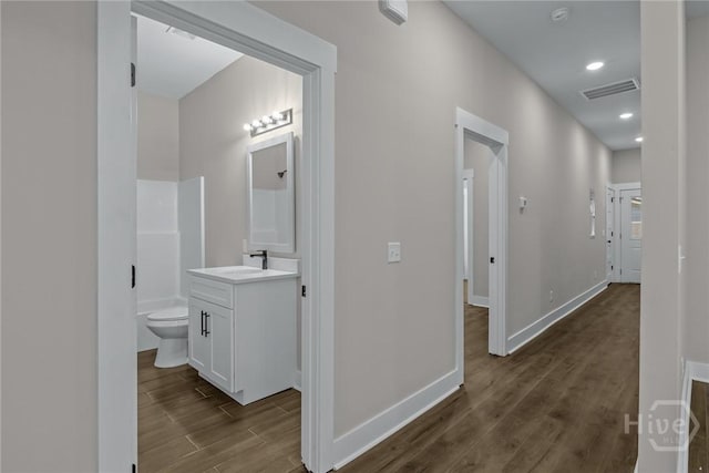 17 Nelson St, Savannah, GA 31415 - hall with dark wood-style flooring, baseboards, a sink, and recessed lighting