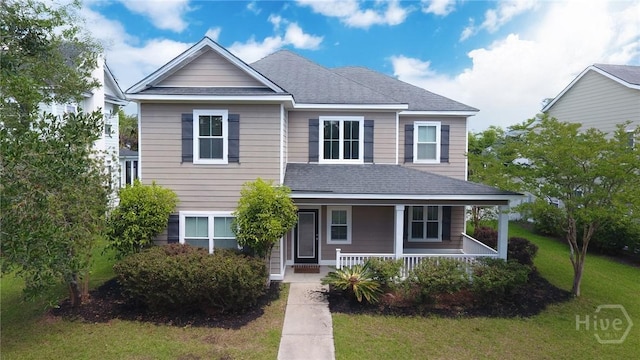 225 James Dunham Pkwy, Richmond Hill, GA 31324 - view of front of house with a front lawn, a shingled roof, and a porch