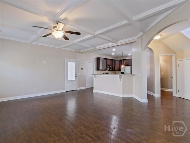 225 James Dunham Pkwy, Richmond Hill, GA 31324 - unfurnished living room with arched walkways, ceiling fan, baseboards, coffered ceiling, and dark wood-style floors
