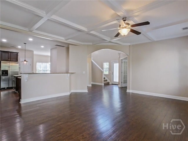 225 James Dunham Pkwy, Richmond Hill, GA 31324 - unfurnished living room with arched walkways, coffered ceiling, recessed lighting, a ceiling fan, and baseboards