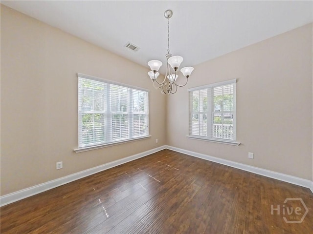 225 James Dunham Pkwy, Richmond Hill, GA 31324 - empty room featuring a chandelier, dark wood-style flooring, and baseboards