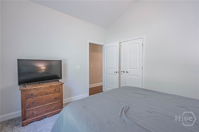 bedroom featuring vaulted ceiling, baseboards, and carpet floors