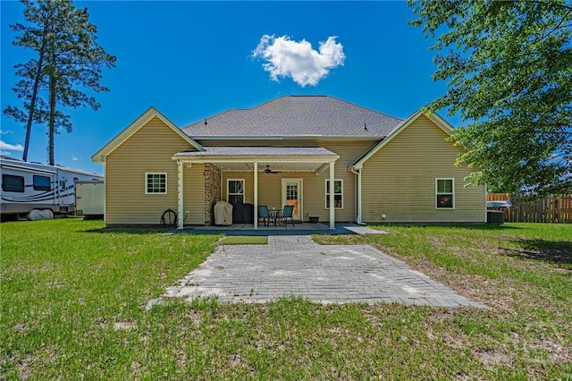 rear view of house with ceiling fan and a patio area