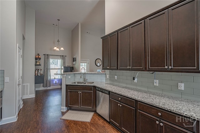 kitchen with dishwasher, a sink, high vaulted ceiling, dark wood-style flooring, and a peninsula