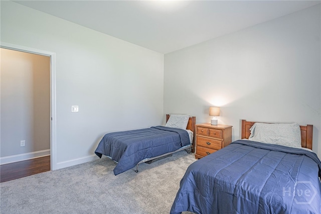 bedroom featuring carpet floors and baseboards