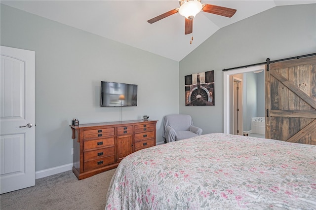 bedroom with vaulted ceiling, light carpet, a barn door, baseboards, and a ceiling fan