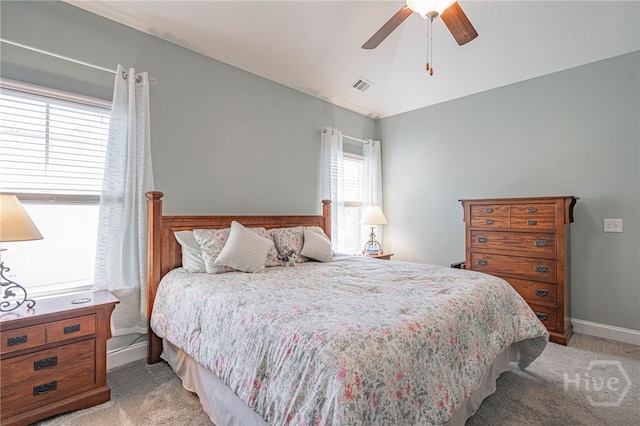 bedroom with light colored carpet, baseboards, and ceiling fan