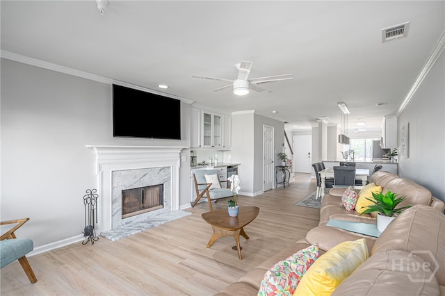 3005 River Dr Unit 209B, Savannah, GA 31404 - living area with crown molding, light wood-type flooring, baseboards, and ceiling fan