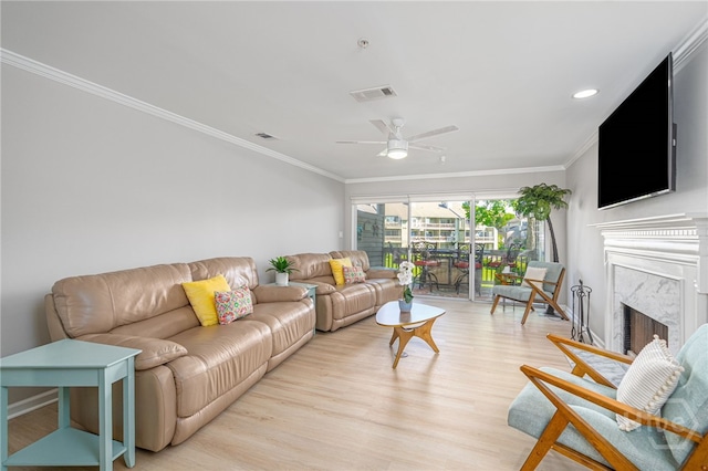 3005 River Dr Unit 209B, Savannah, GA 31404 - living area with ornamental molding, light wood-style flooring, a ceiling fan, a high end fireplace, and recessed lighting