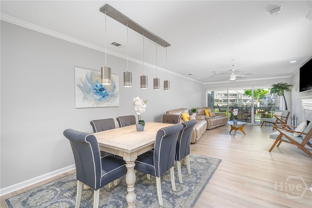3005 River Dr Unit 209B, Savannah, GA 31404 - dining space with light wood-style floors, crown molding, a ceiling fan, and baseboards