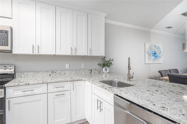 3005 River Dr Unit 209B, Savannah, GA 31404 - kitchen featuring stainless steel appliances, ornamental molding, a sink, white cabinets, and light stone countertops