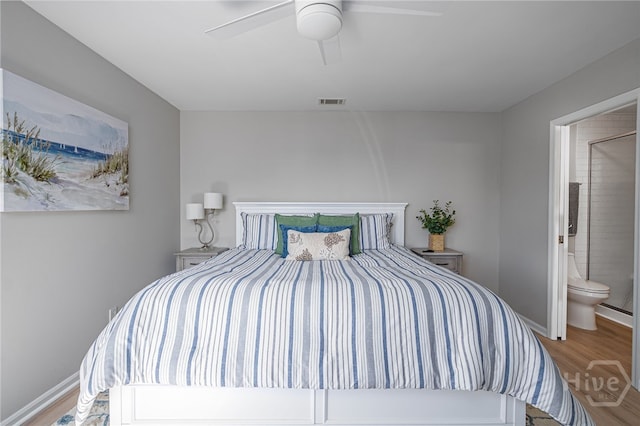 3005 River Dr Unit 209B, Savannah, GA 31404 - bedroom featuring wood finished floors, ceiling fan, baseboards, and connected bathroom