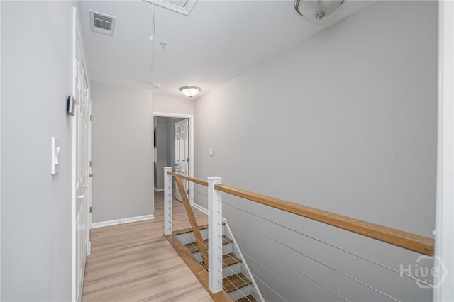 3005 River Dr Unit 209B, Savannah, GA 31404 - hallway featuring an upstairs landing, light wood finished floors, attic access, and baseboards