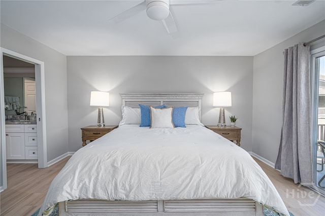3005 River Dr Unit 209B, Savannah, GA 31404 - bedroom featuring light wood finished floors, ensuite bathroom, a sink, and baseboards